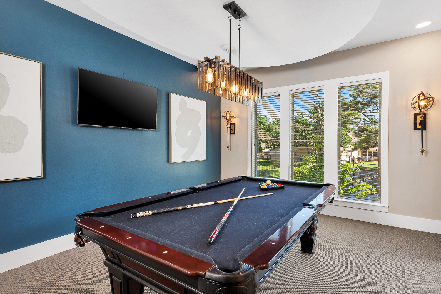 a game room with a pool table and a tv