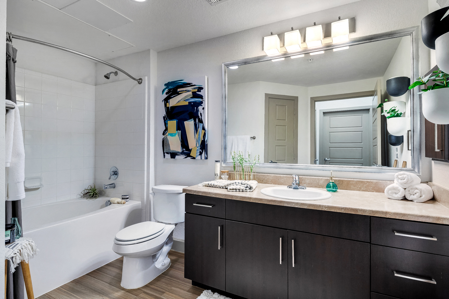 a bathroom with a large mirror and a sink and a toilet