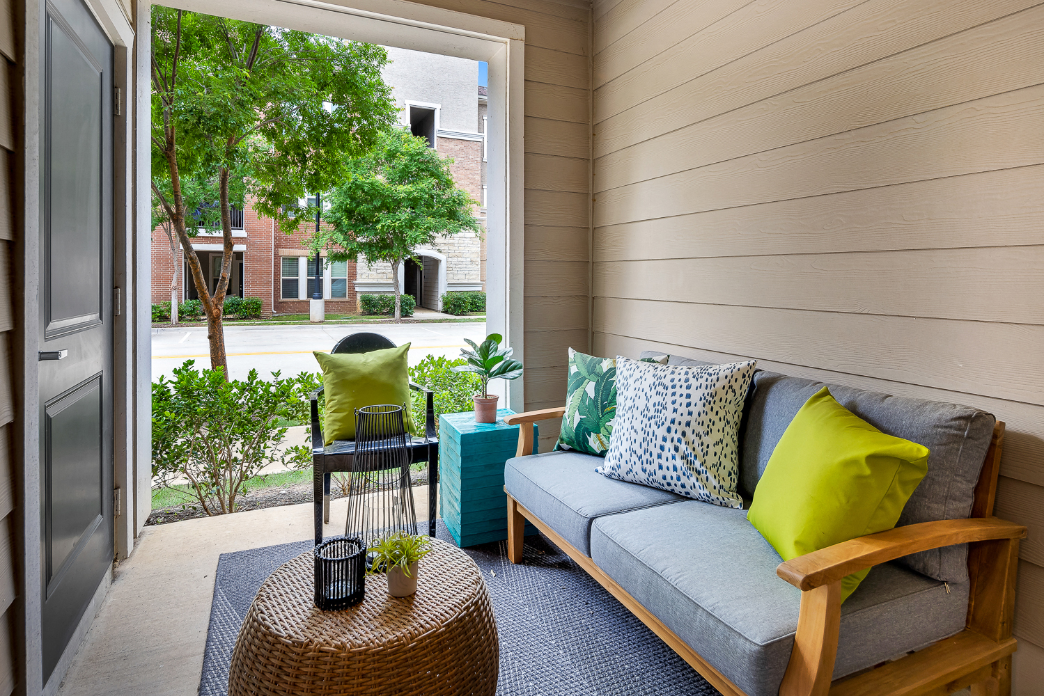a porch with a couch and a table and a window