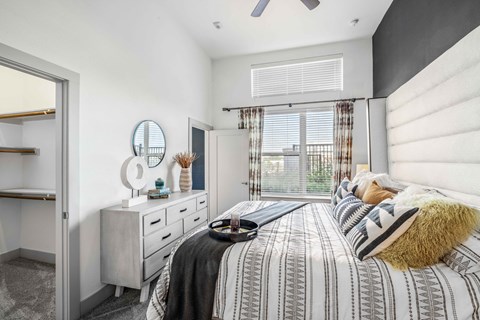 a bedroom with a bed and a window