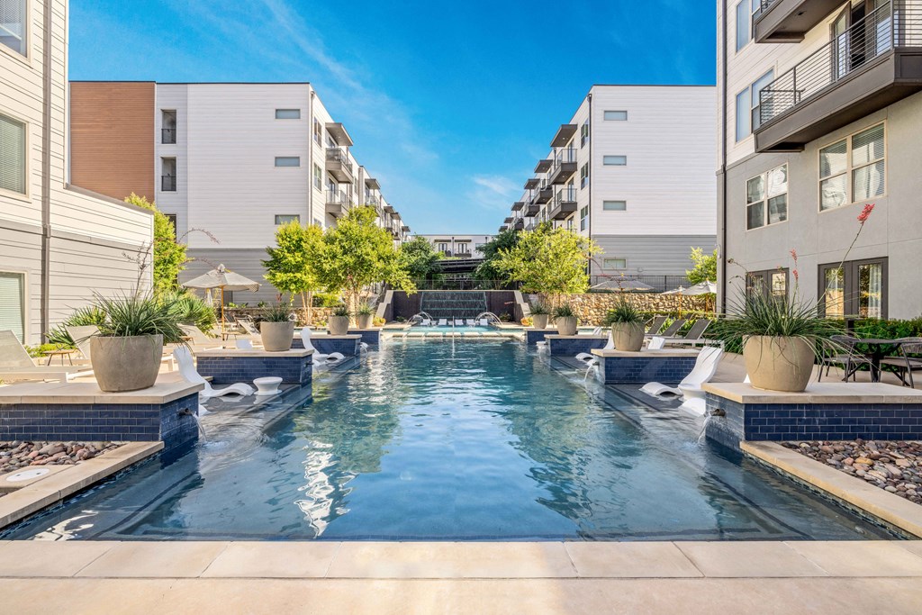 an apartment with a swimming pool in the middle of two buildings