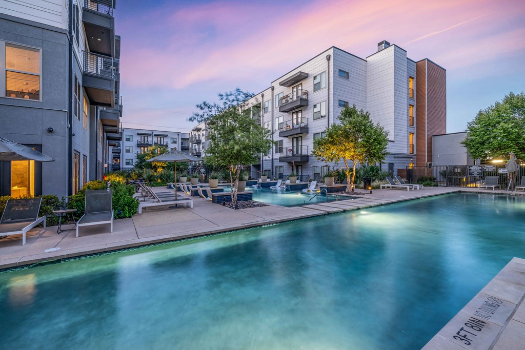 a swimming pool with apartments in the background