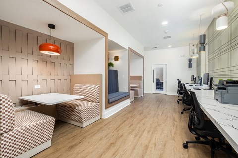 A modern office space with a wooden floor and a white table.