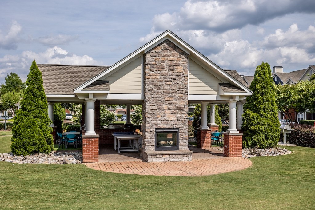 a home with a stone fireplace in the front yard