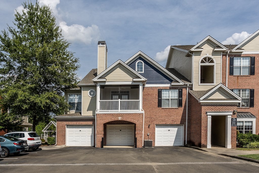 a house with two garages and a parking lot