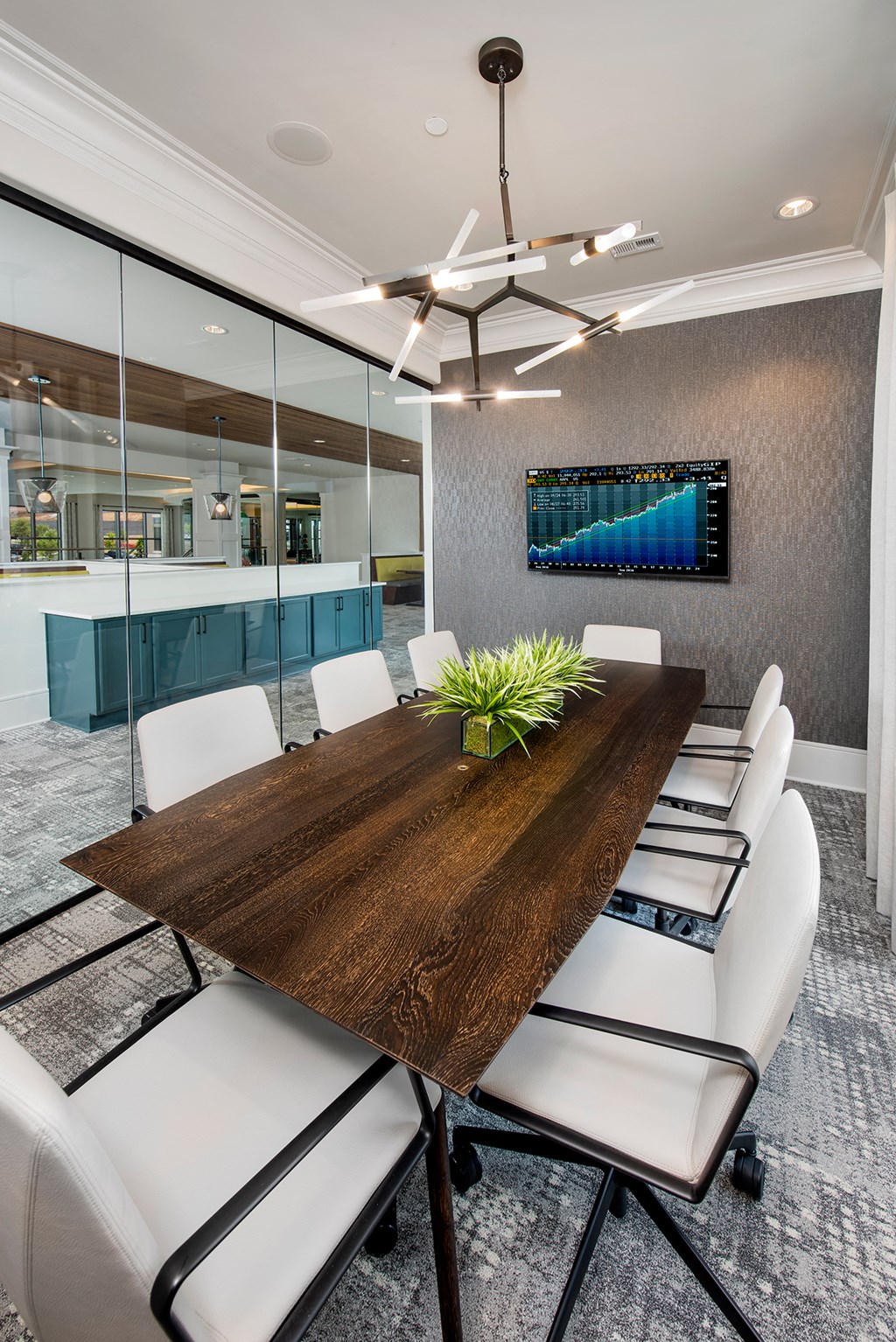 a conference room with a wooden table and white chairs
