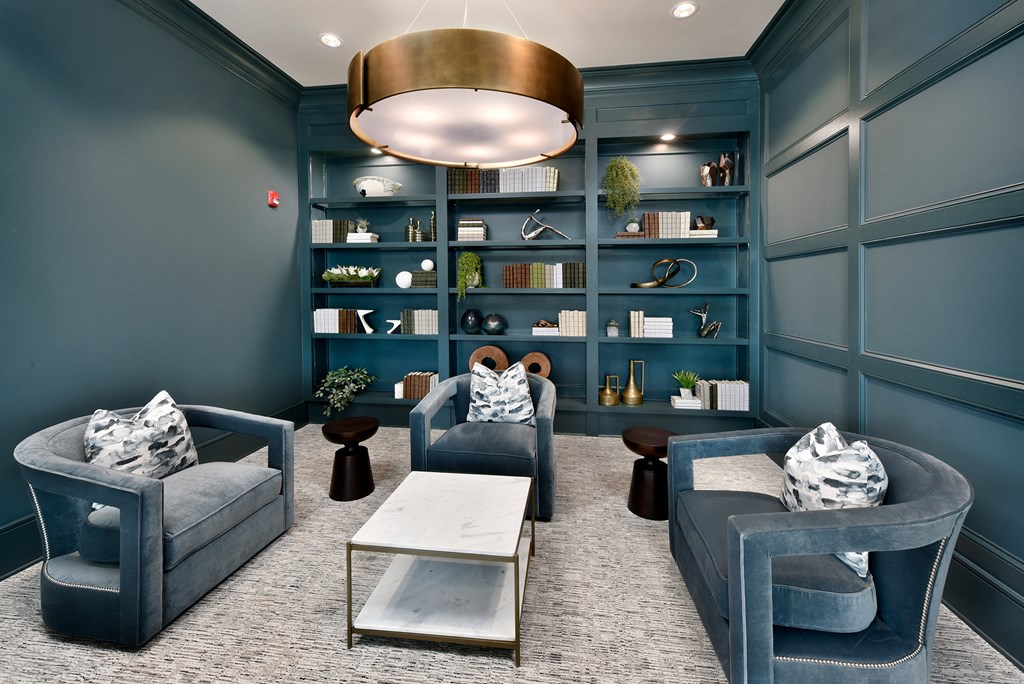 a living room with two blue chairs and a coffee table
