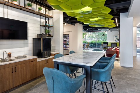 A modern kitchen with a dining table and chairs.