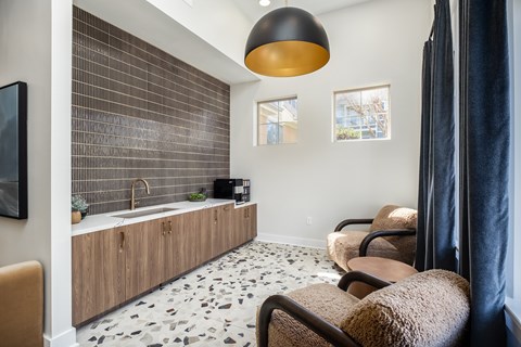 A modern bathroom with a sink, a mirror, and a shower.
