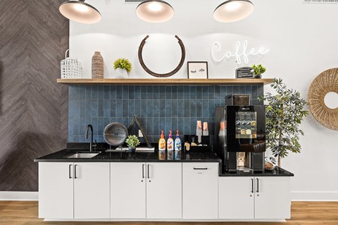 a kitchen with white cabinets and a coffee machine on the counter
