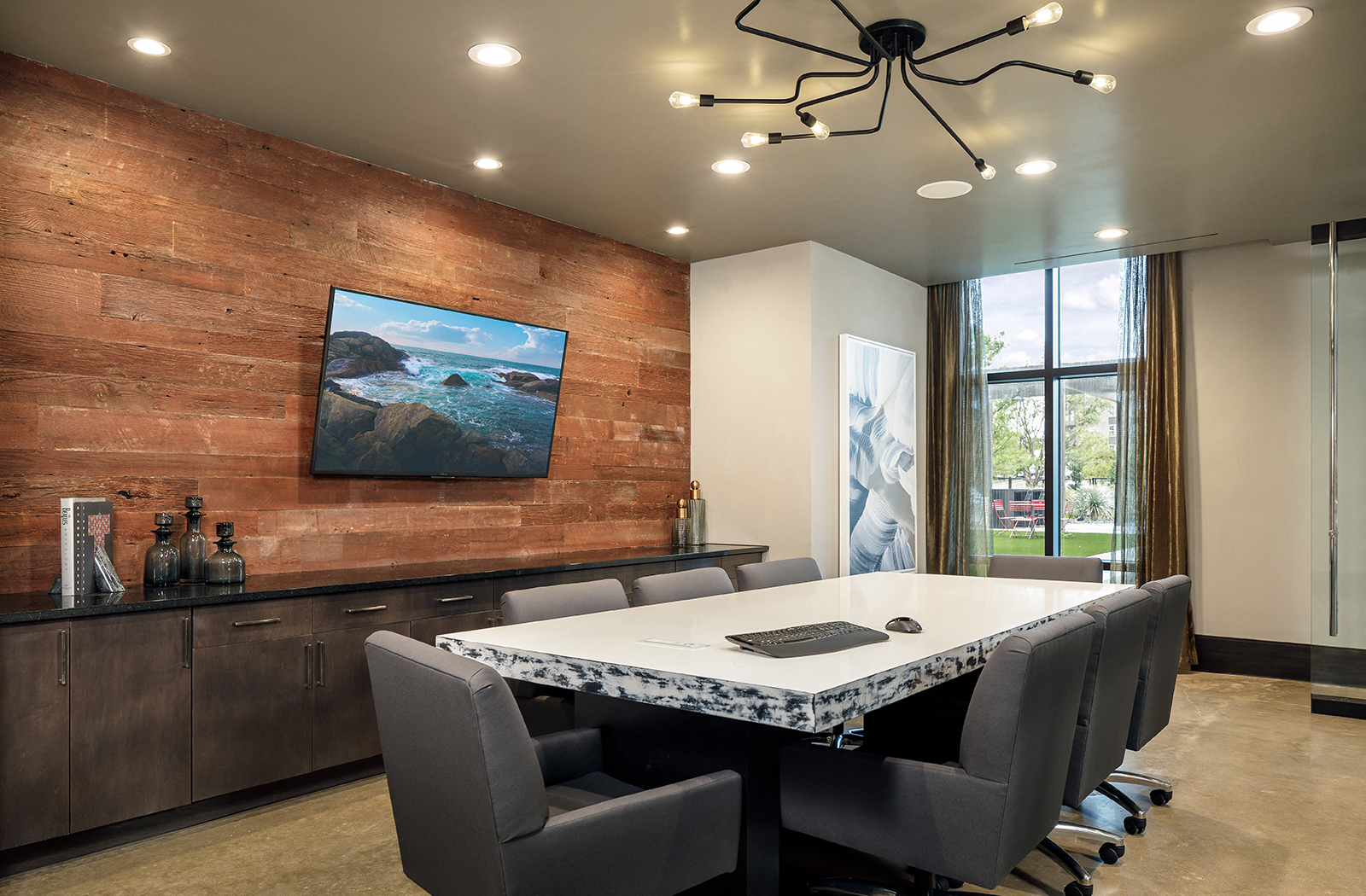 a conference room with a marble table and chairs