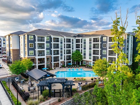 an aerial view of an apartment building with a swimming pool