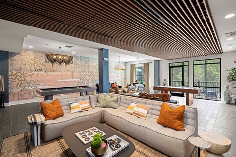 a living room with a couch and a pool table