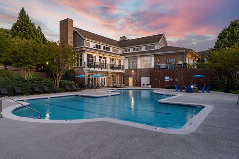 A large house with a pool in front.