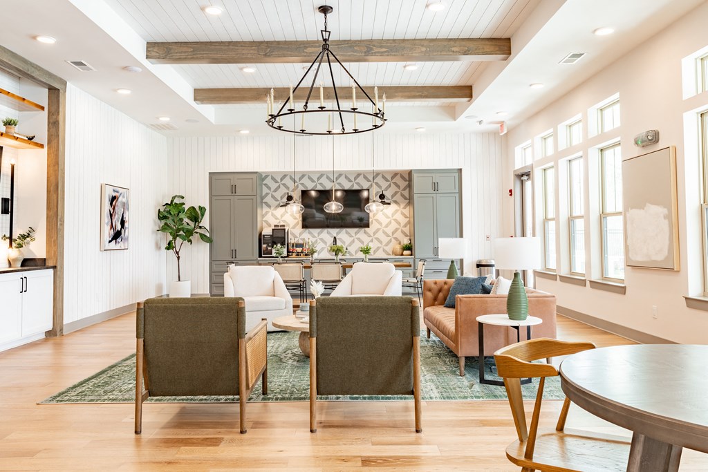 a living room filled with furniture and a large chandelier