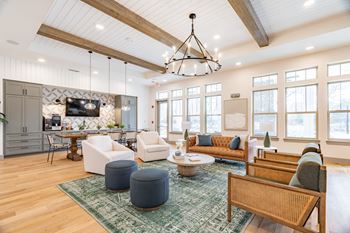 a living room filled with furniture and a large chandelier