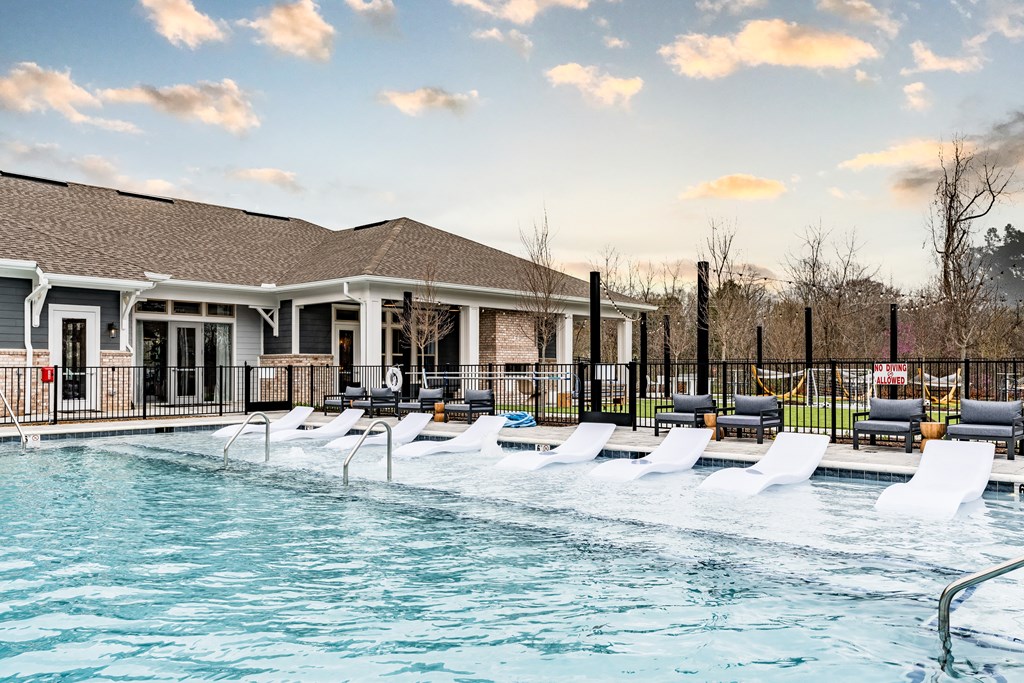pool with lounge chairs at the bradley braddock road station apartments