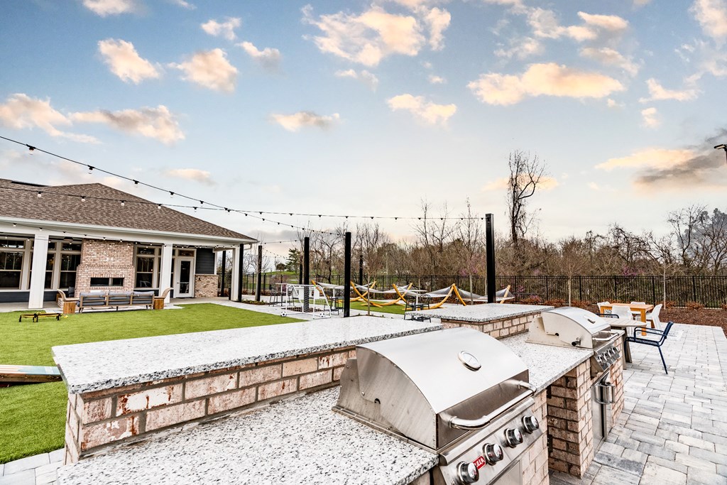 the backyard has a large patio with a grill and bbq