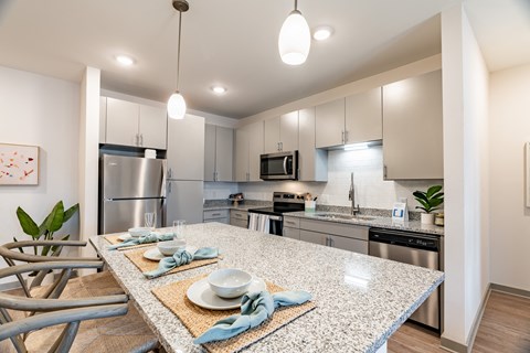 a kitchen with stainless steel appliances and a granite counter top