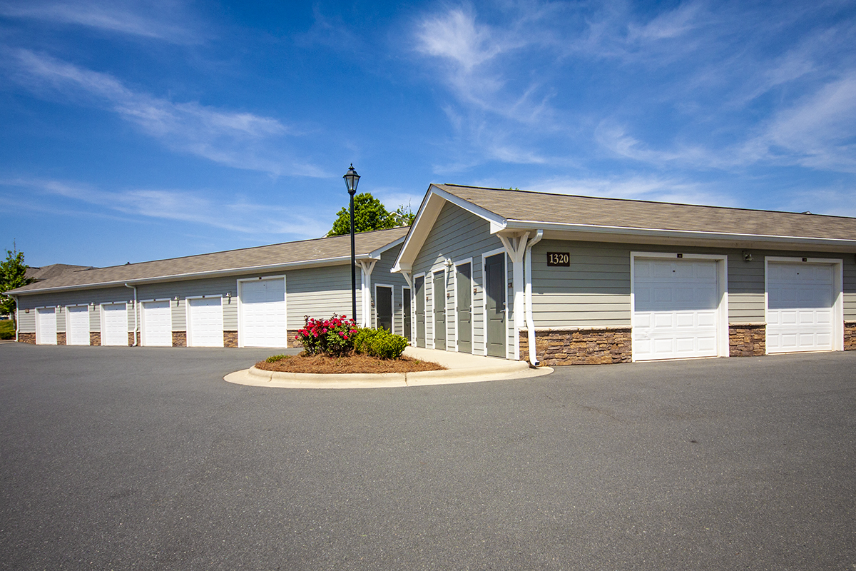 a parking lot in front of a building with white doors
