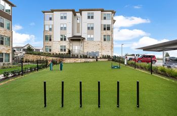 a game of croquet on a lawn in front of a building