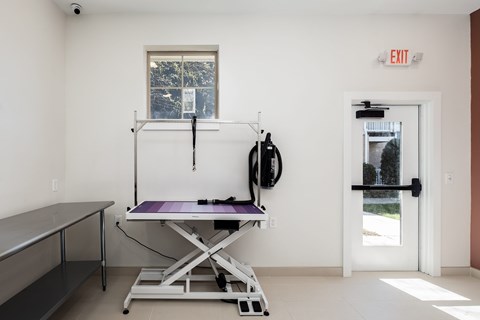 A room with a table and a window.