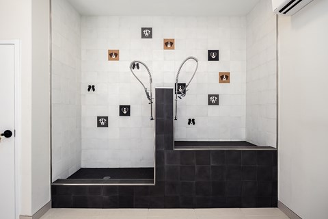 A modern bathroom with a walk-in shower and a black bench seat.