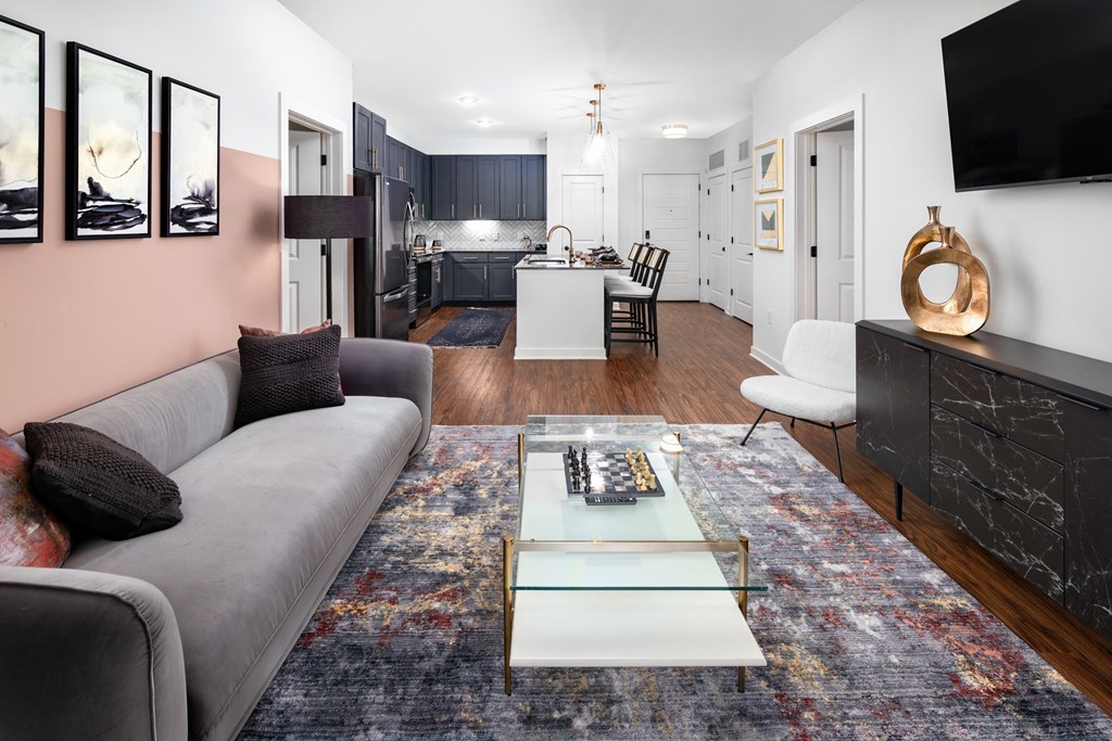 a living room with a gray couch and a glass coffee table