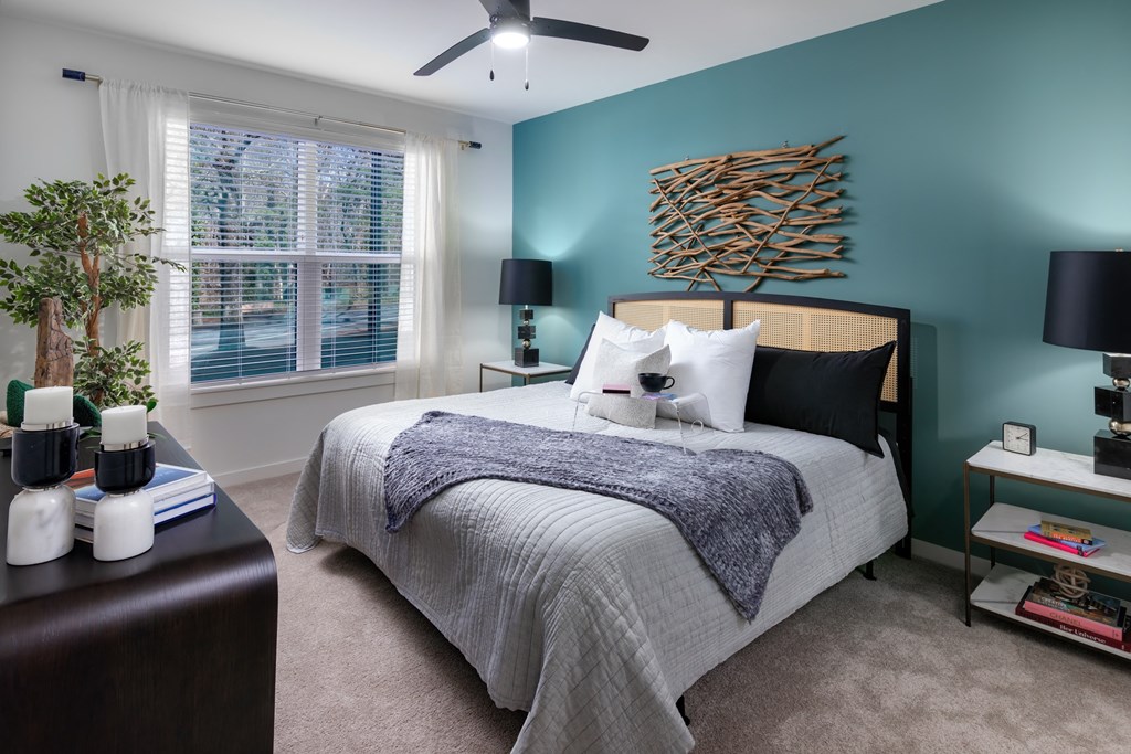 a bedroom with a bed and a window