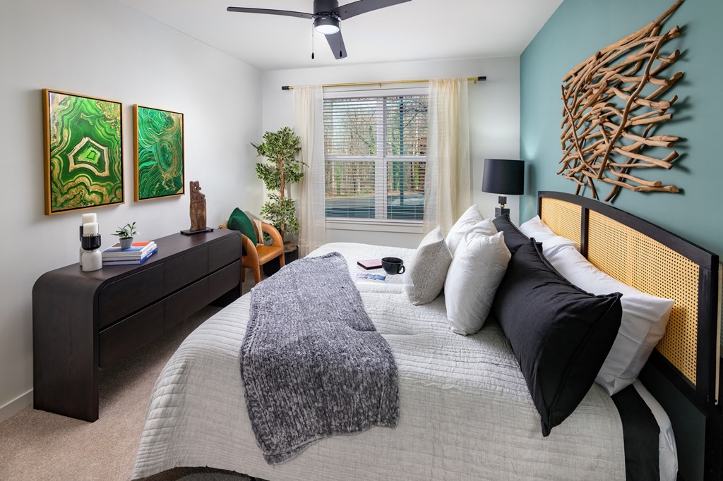 a bedroom with a large bed and a large window