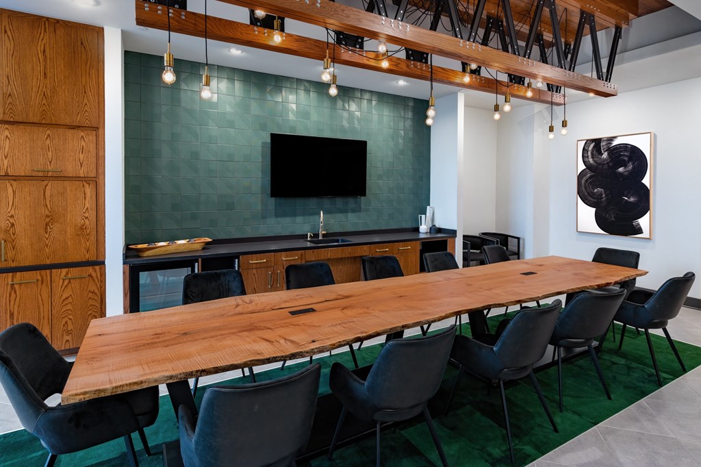 a conference room with a long wooden table and chairs