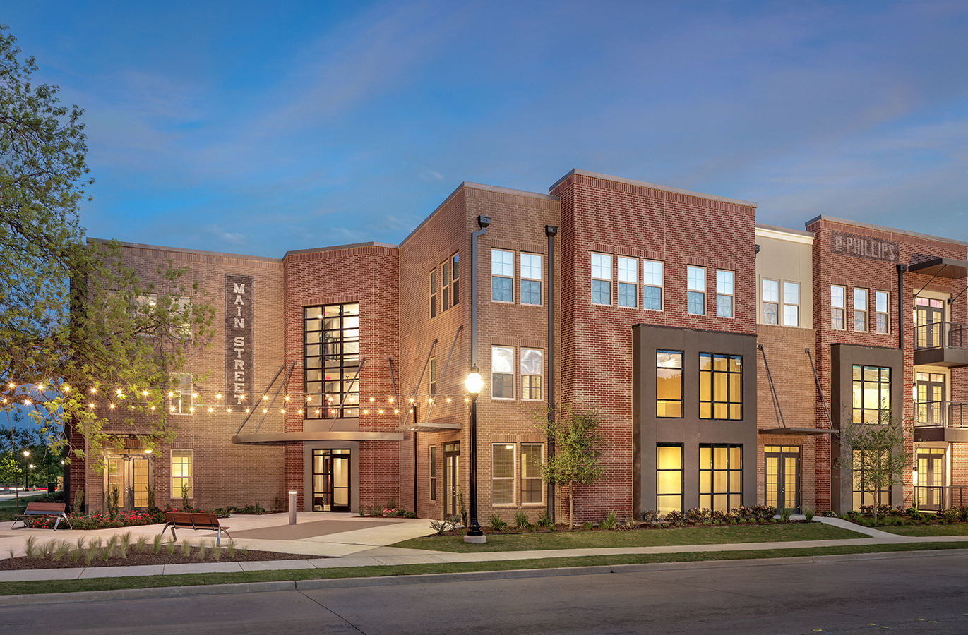 a rendering of a large brick building at night with lights