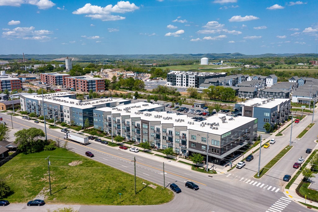 an aerial view of a city with buildings and cars on the street