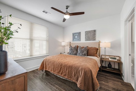 a bedroom with a bed and a ceiling fan