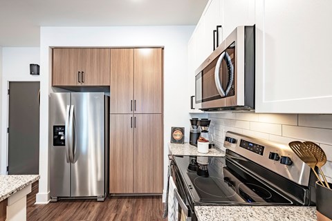 a kitchen with stainless steel appliances and a microwave