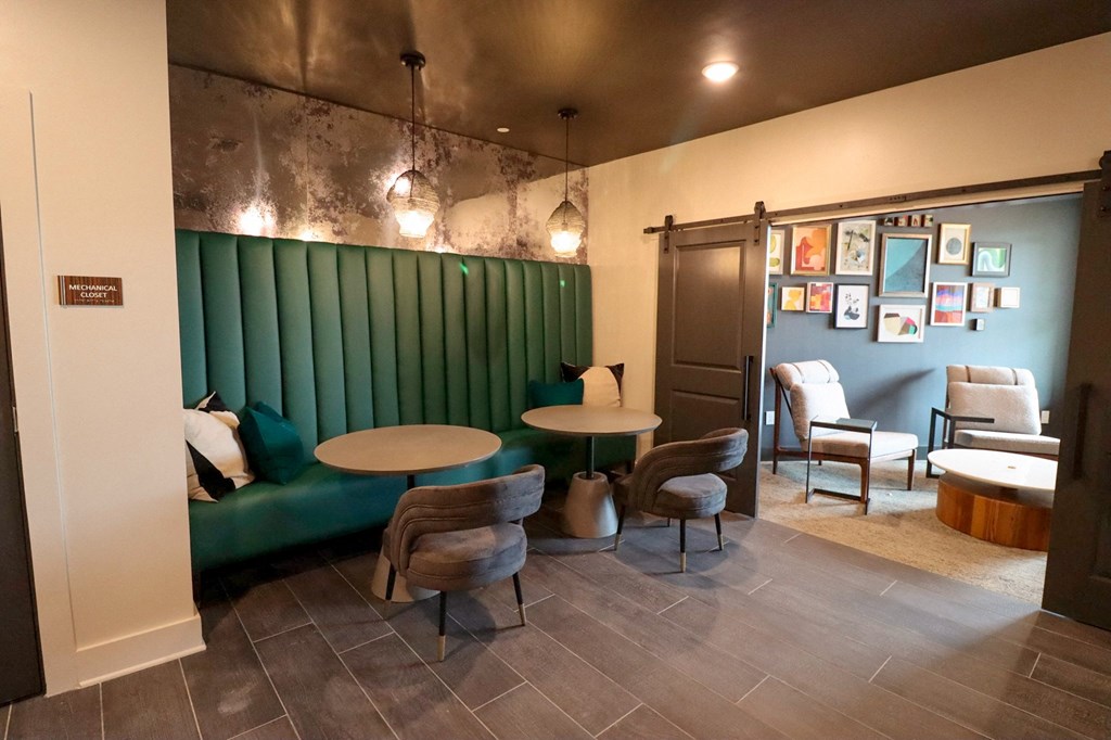 a dining room with a green booth and tables and chairs