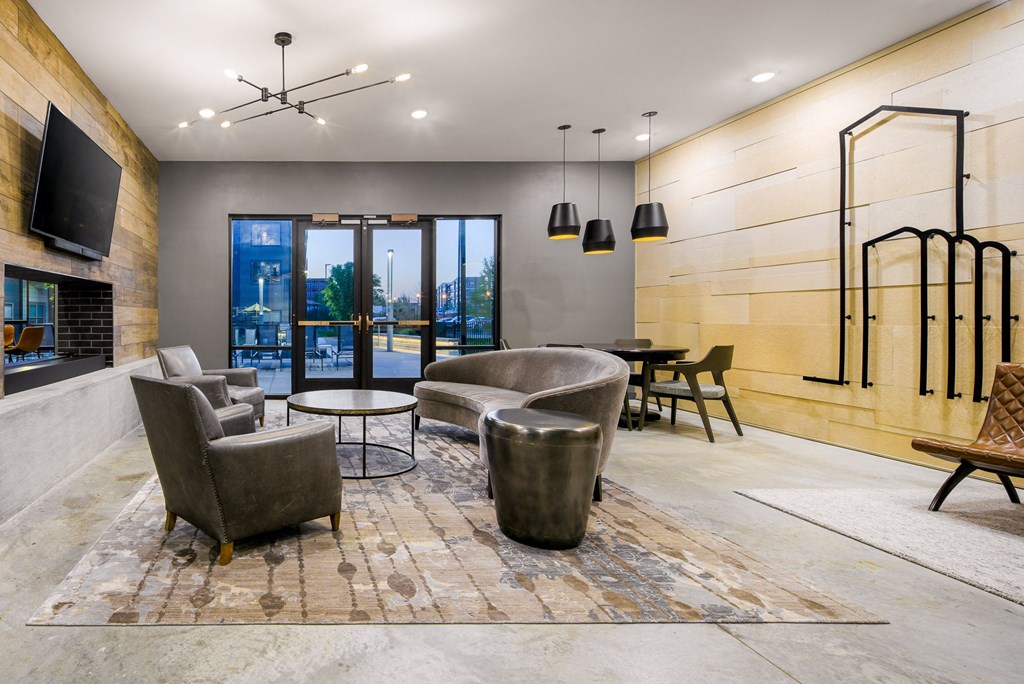 a living room with couches and chairs and a television