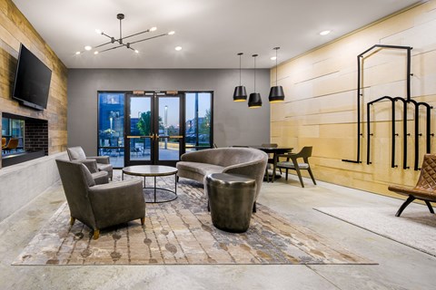a living room with couches and chairs and a television
