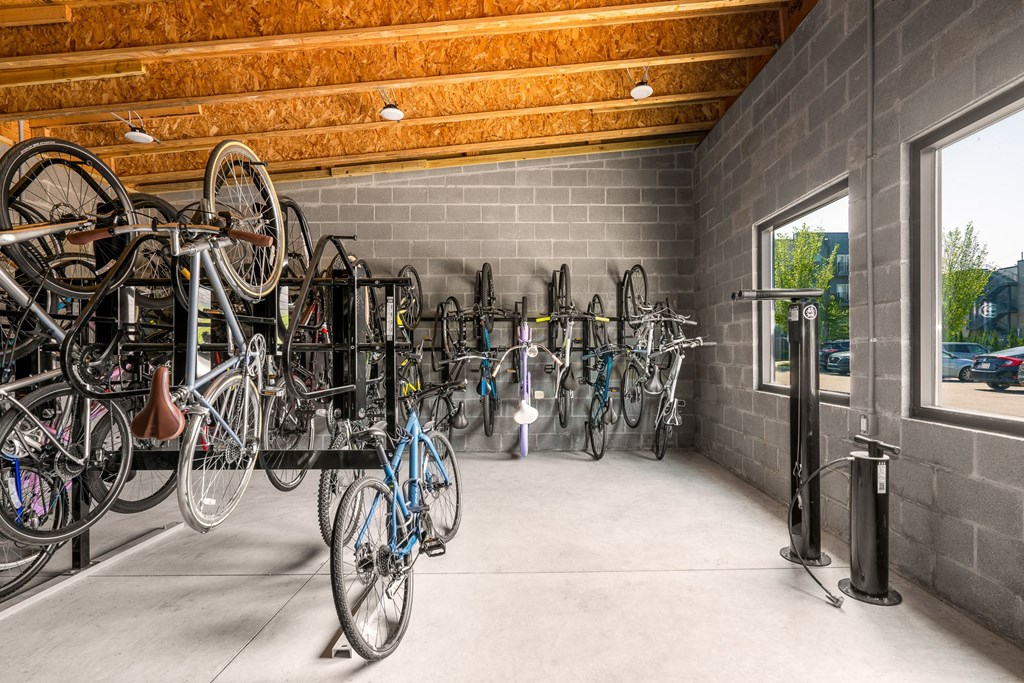 the bike room is filled with bikes and a wall of windows