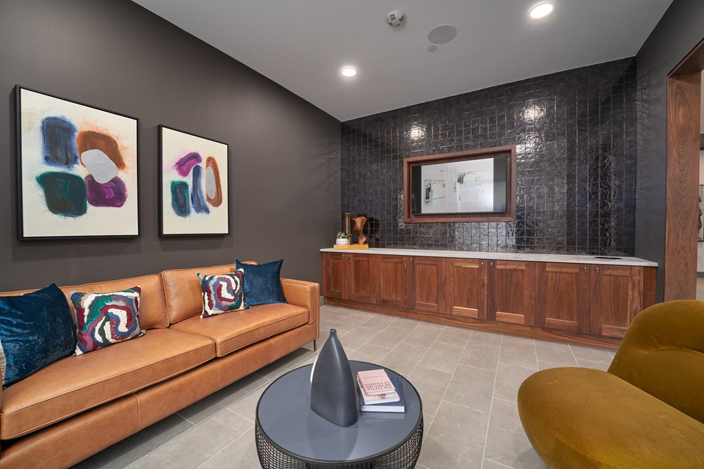 A living room with a brown couch and a coffee table.