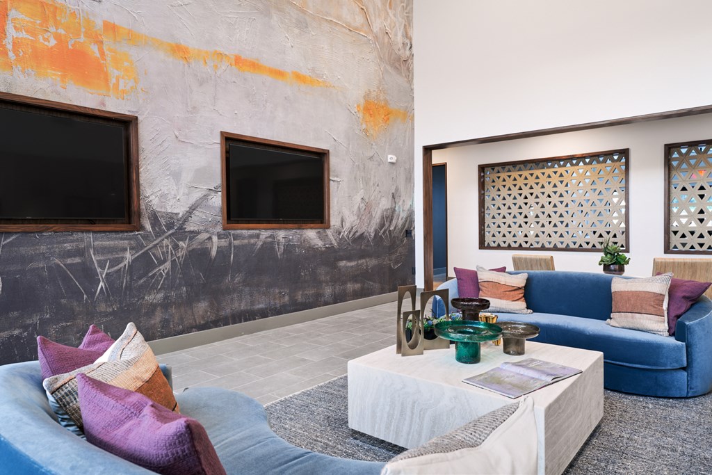 A living room with a grey couch and a white coffee table.