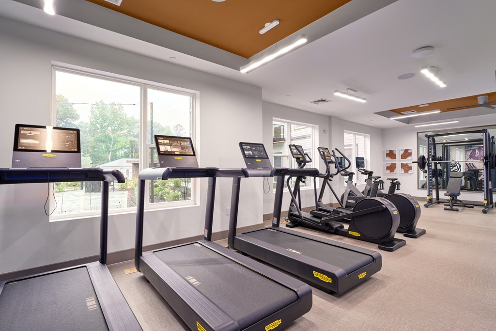 A gym with treadmills and exercise bikes.