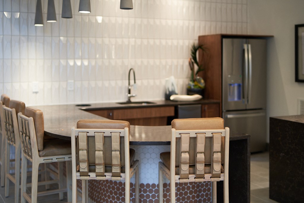 A kitchen with a table and chairs.
