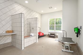 A room with a tiled wall and a table.