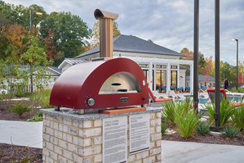 A brick oven with a sign in front of a building.