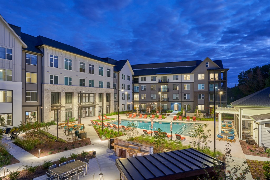 A large building with a pool in the courtyard.