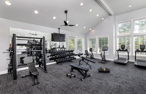 A spacious home gym with a variety of equipment.