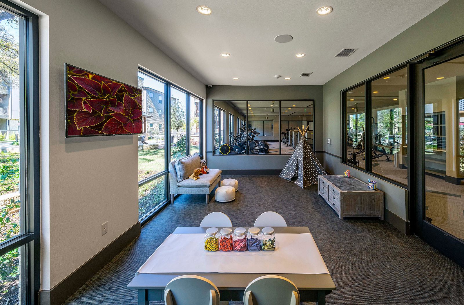 a large living room with a table and chairs