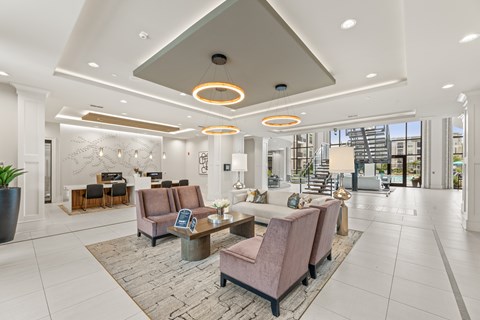 A spacious lobby with a reception desk and seating area.