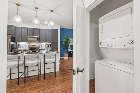 A kitchen with a white oven and a blue wall.